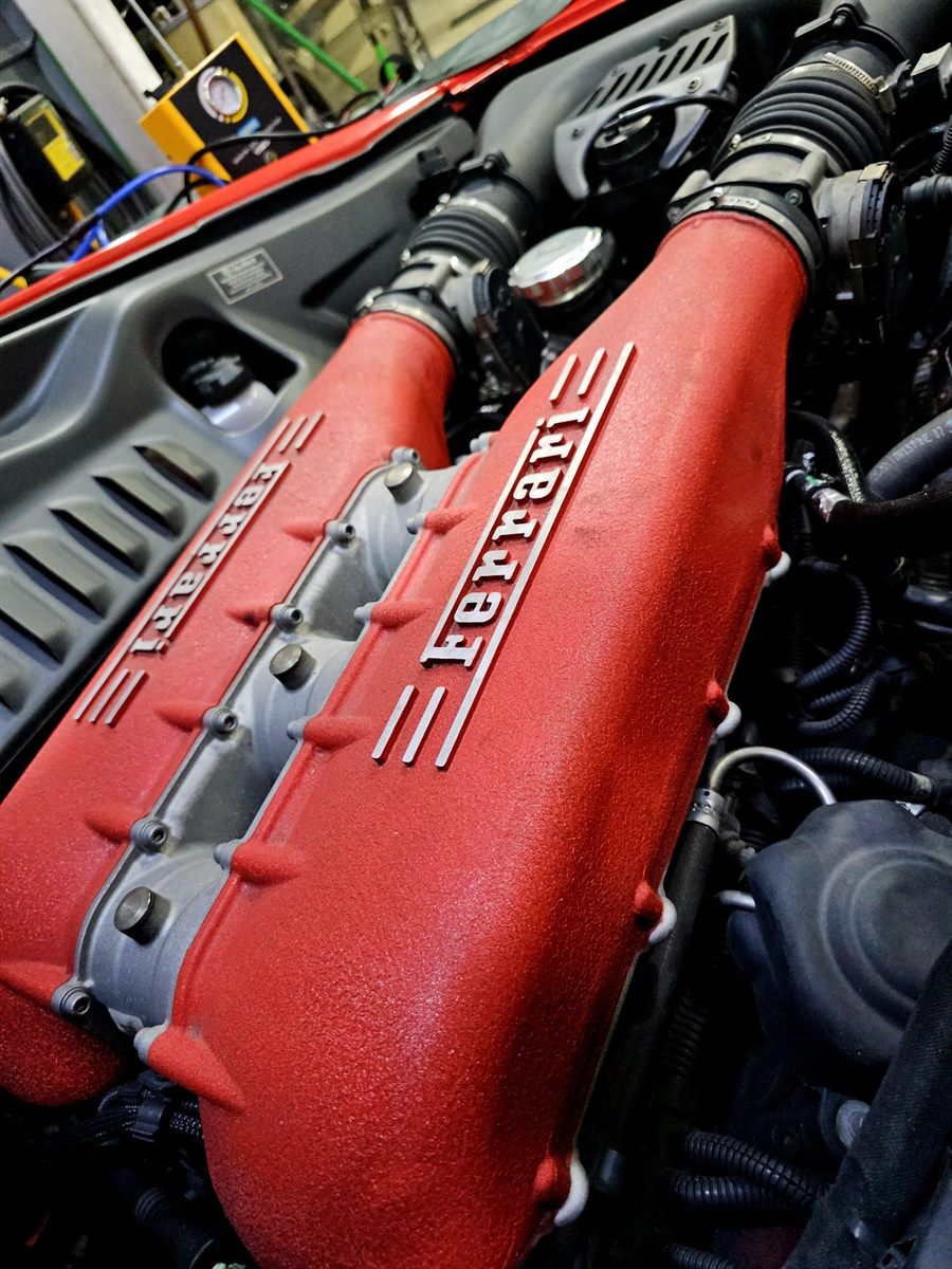 Ferrari engine bay with red intake manifold